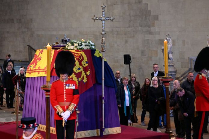 People pay respects at Britain's Queen Elizabeth's coffin, following her death, as she lies in state, in London, Britain